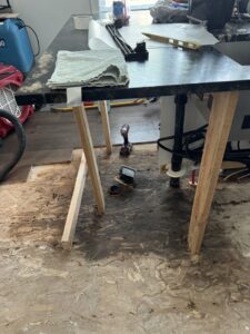 An exposed wet subfloor with dark stains and removed flooring, clearly showing the effects of water damage and the need for restoration by Standard Restoration in Salt Lake City, UT.