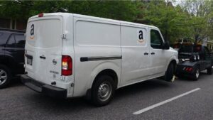 A white Amazon delivery van being towed by Whitelock Towing in Baltimore, MD.
