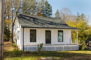 A newly sided white house with modern board and batten siding by Atlantic Roofing and Siding in East Hartford, CT.