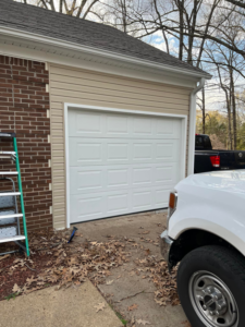 A white garage door recently installed or repaired at a residence by Ultimate Garage Doors LLC in Olive Branch, MS.