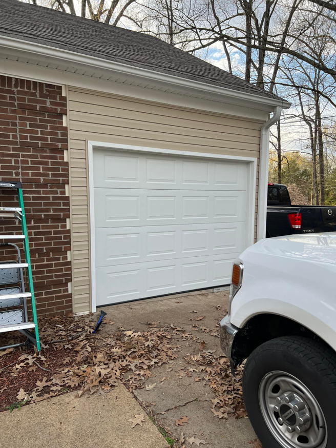 A white garage door recently installed or repaired at a residence by Ultimate Garage Doors LLC in Olive Branch, MS.