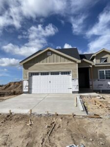 A white garage door installed on a new home under construction by Apex Garage Doors in Columbus, OH.