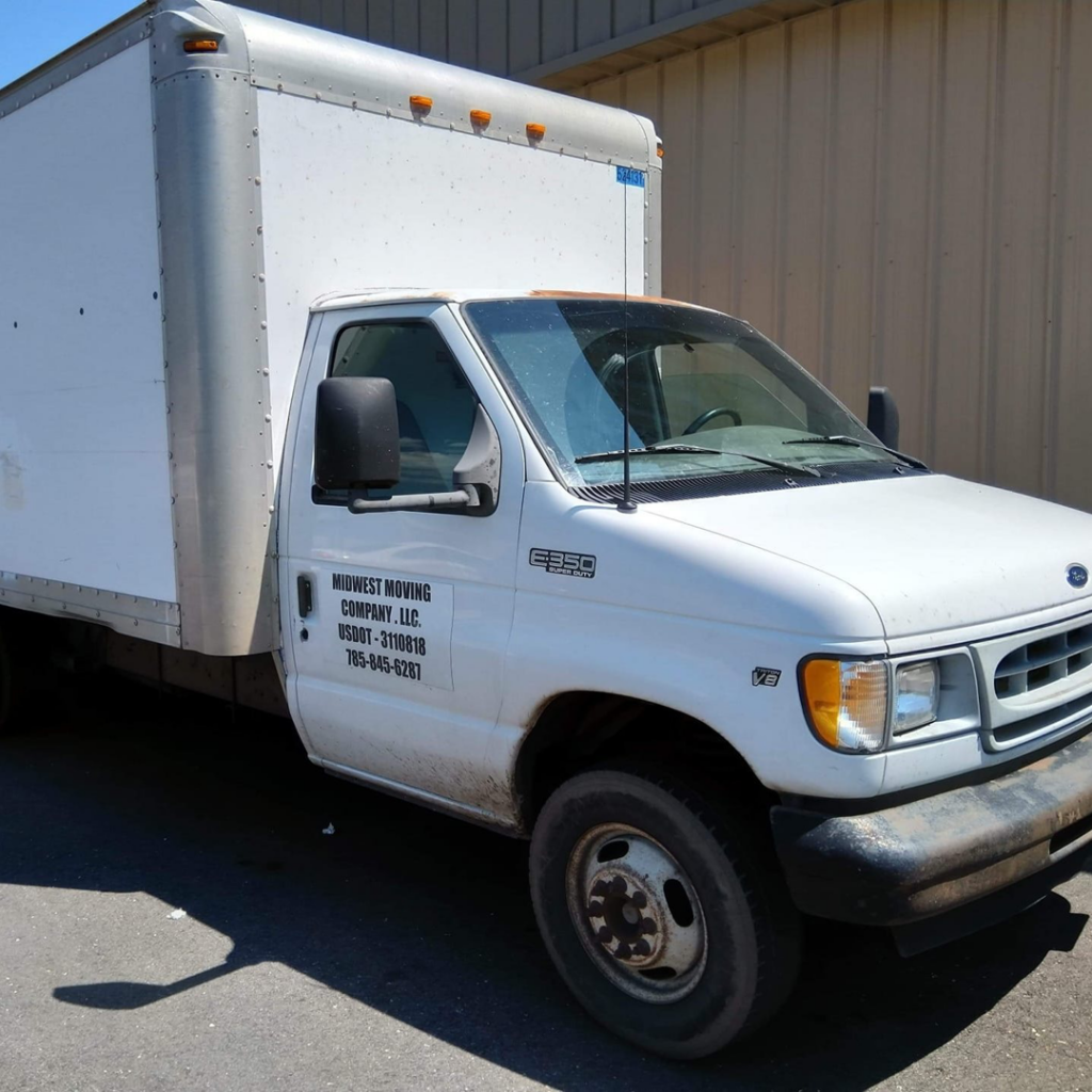 A white moving truck with the business name Midwest Moving Company LLC. in Topeka, KS, ready for service.