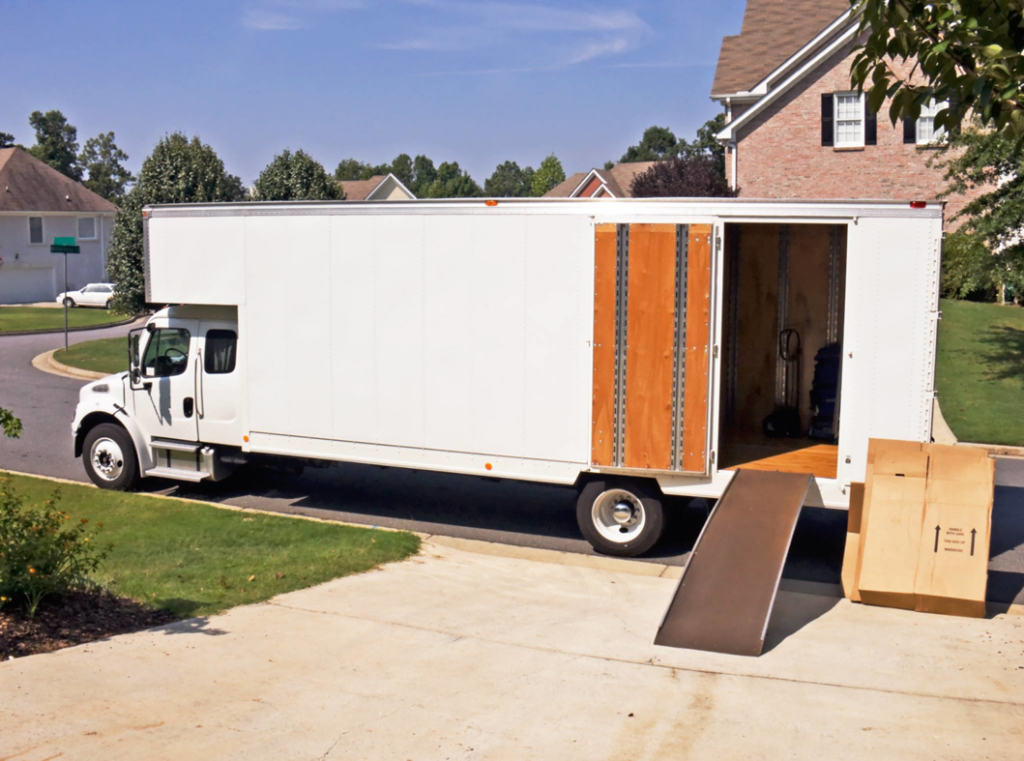 A large white moving truck with its ramp down and boxes outside, ready for a residential move by A Few Good Movers in Minneapolis, MN.