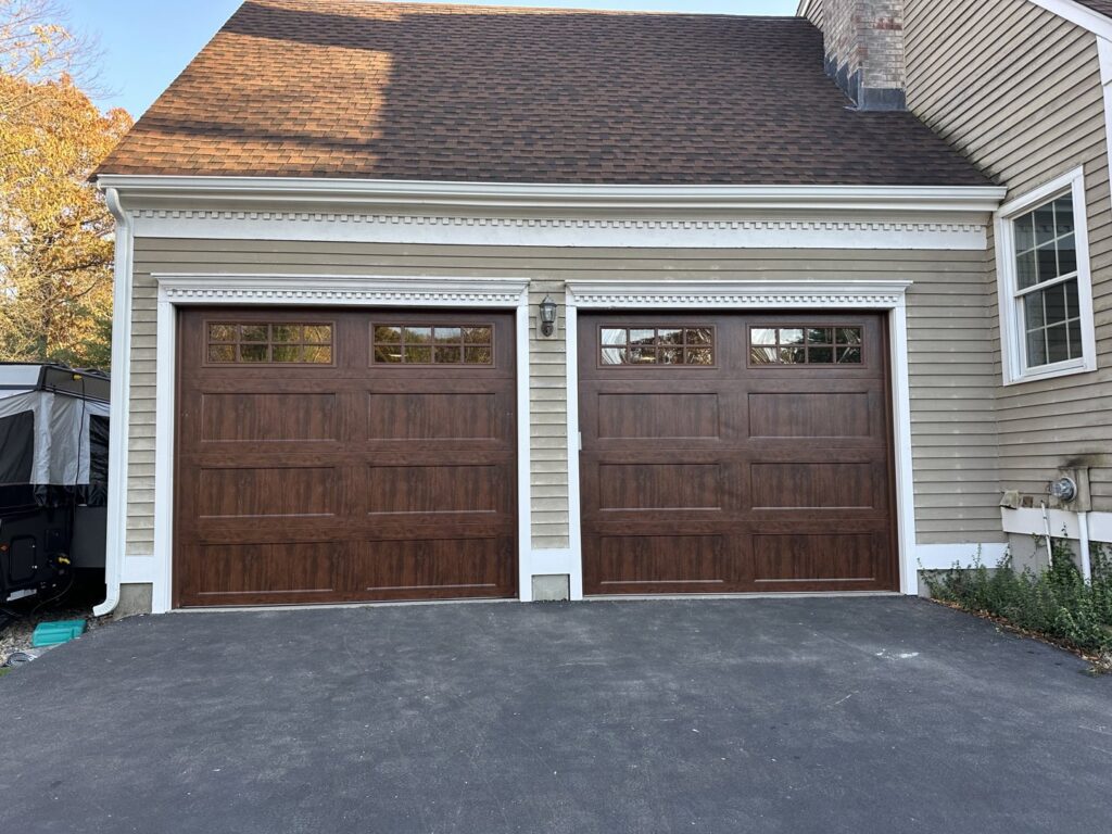 A white panel garage door, likely a new installation or replacement by Compton Doors, Inc. in Attleboro, MA