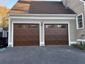 A white panel garage door, likely a new installation or replacement by Compton Doors, Inc. in Attleboro, MA