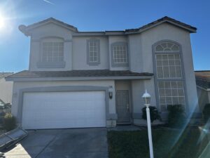 A white panel garage door installed on a residential home by K & B Door Co. in Las Vegas, NV