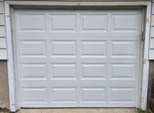 A white panel garage door, showcasing repair or new installation work by The Garage Door Guys, LLC in New Haven, CT.