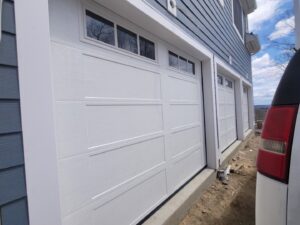 Close-up of a newly installed white panel garage door with windows by RidgeLine Overhead Garage Door of CT in Danbury, CT