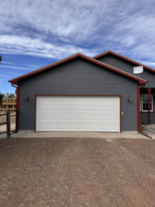 A white paneled residential garage door installed by Cowboy State Garage Doors, LLC in Cheyenne, WY.
