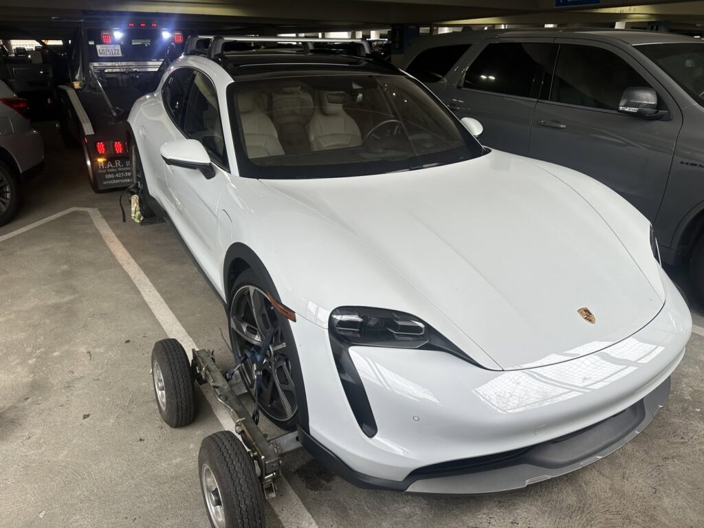 A white Porsche car on dollies, ready for towing by R towing Services in Sacramento, CA.