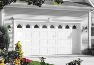 A beautiful white residential garage door with decorative windows by Frontier Garage Door in Anchorage, AK.