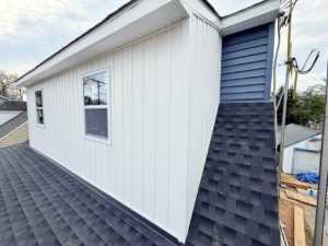 Close-up of new white vertical and blue horizontal siding on a house by High Quality Exteriors in Rockville, MD.
