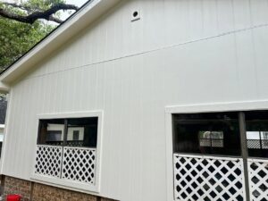 A house with modern white vertical siding and windows, a completed project by Ideal Siding Austin in Austin, TX.