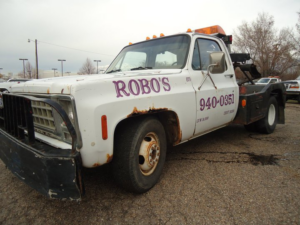 A white wrecker tow truck with Robo's Towing branding in Marriott-Slaterville, UT, for heavy-duty towing.
