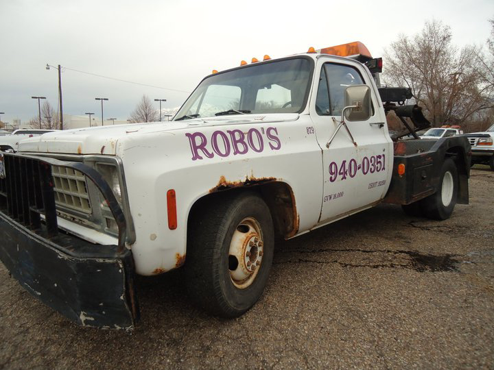 A white wrecker tow truck with Robo's Towing branding in Marriott-Slaterville, UT, for heavy-duty towing.