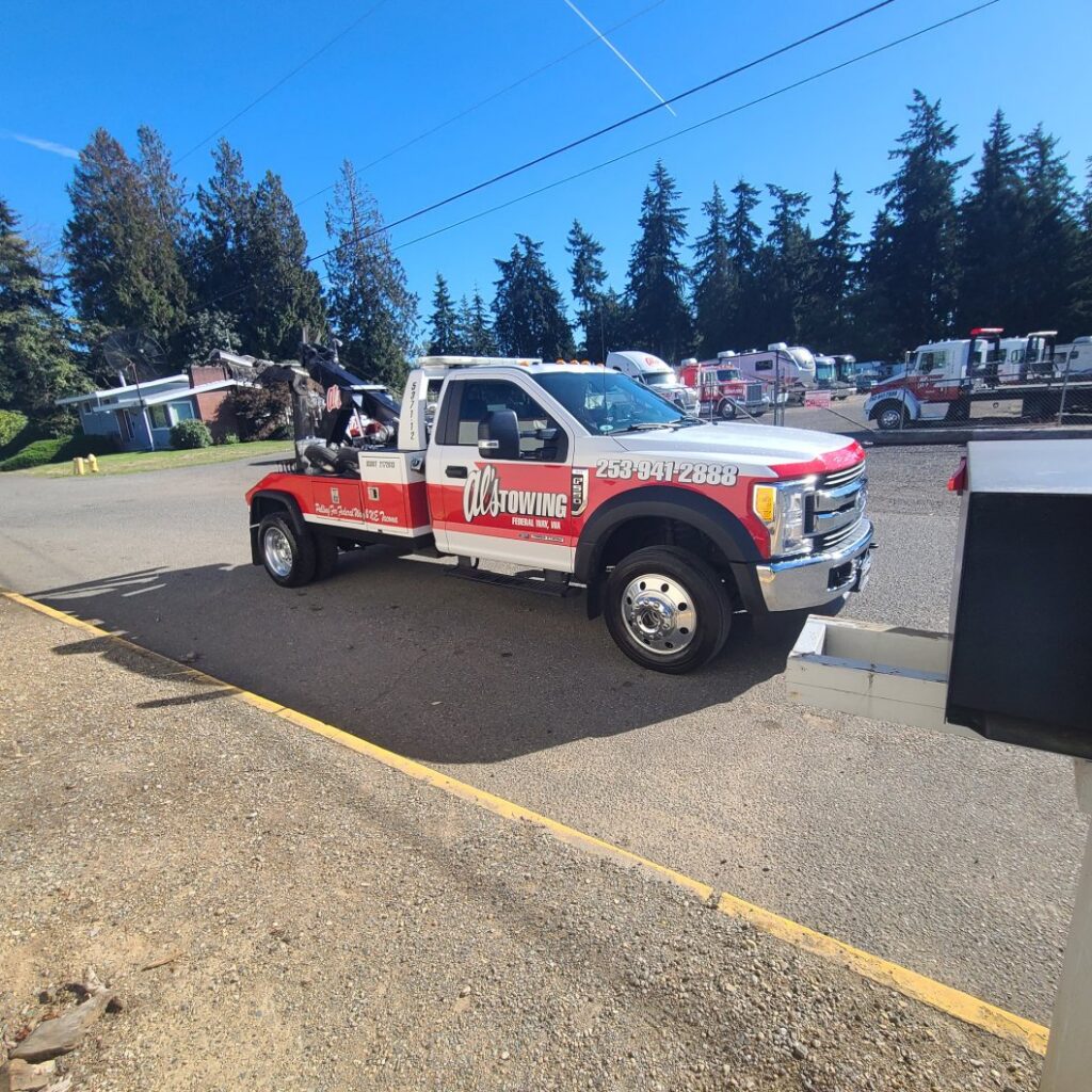 A white wrecker tow truck from Al's Towing parked on a sunny day in Jackson, NJ