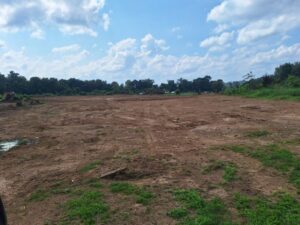 A wide view of a large cleared land area, demonstrating site preparation by Cornerstone Demolition & Excavation in Lexington, KY