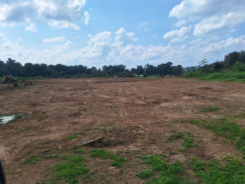 A wide view of a large cleared land area, demonstrating site preparation by Cornerstone Demolition & Excavation in Lexington, KY