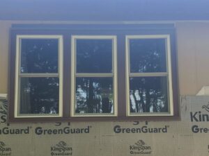 New window installation with house wrap visible, preparing for siding by River City Exteriors in San Antonio, TX