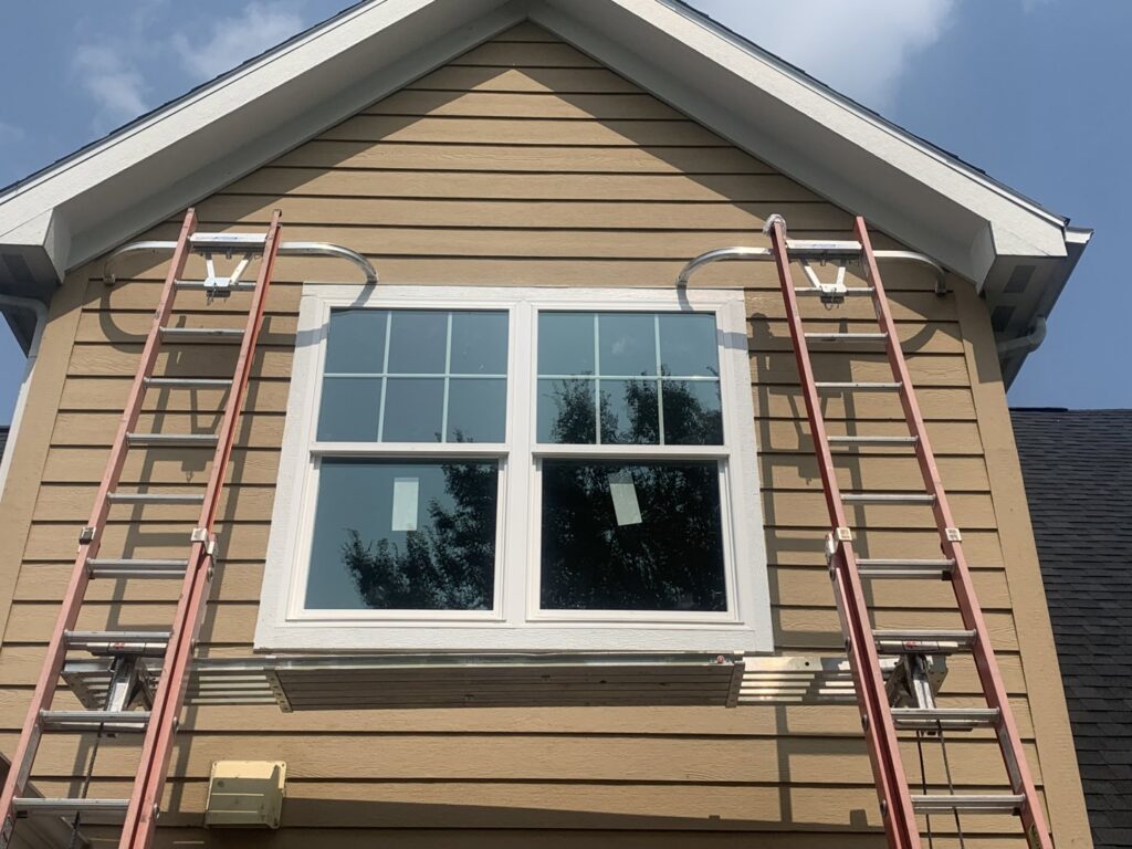Exterior work including window installation and siding on a house by Freeman Exteriors in Danville, IL.