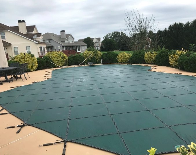 A pool securely covered for the winter season, showcasing a professional pool closing service by Chlorine Clean Pool Services in Wilmington, DE.