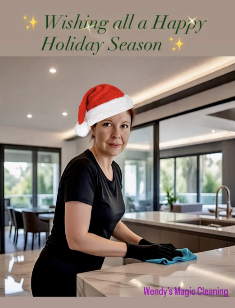 A woman wearing gloves and a Santa hat cleaning a kitchen counter with a blue cloth for Wendy's Magic Cleaning in Reno, NV.