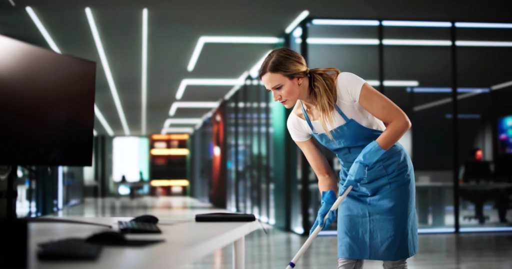 A professional cleaner from Smith Solutions, LLC mopping an office floor in Camden, DE.