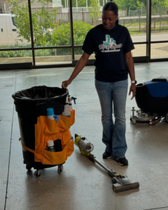 A woman with a cleaning cart and vacuum cleaner, ready for service by Tidy Up Experts LLC in Chicago, IL.