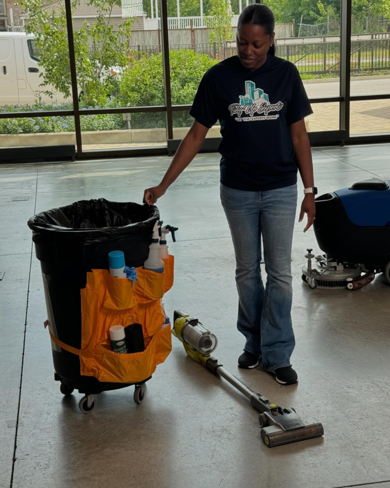 A woman with a cleaning cart and vacuum cleaner, ready for service by Tidy Up Experts LLC in Chicago, IL.