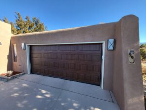 A beautiful new wood-grain style garage door installed by Spartan Garage Doors and More in Albuquerque, NM.
