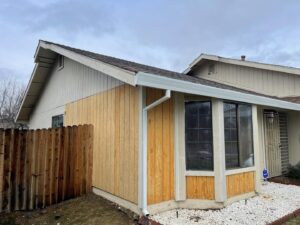 A section of a house exterior with new wood siding installed by Good Life Construction Inc in North Highlands, CA