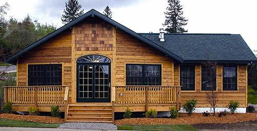 A rustic home featuring beautiful wooden siding and cedar shakes installed by CityWide Roofing Rochester in Webster, NY.