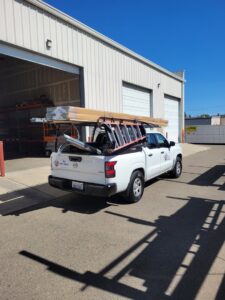 A Carmichael Garage Door work truck loaded with ladders and garage door tracks, ready for a job in Carmichael, CA.