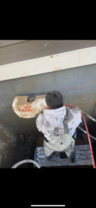 A worker from Independent Concrete Cutter Corp. using a large circular saw to cut concrete in Denver, CO.