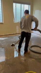 A worker from Western Skies Restoration extracting water from a damaged floor in Gilbert, AZ.