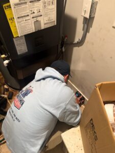 A Minutemen Property Damage Services worker inspecting a wall for moisture near an HVAC unit in North Charleston, SC.