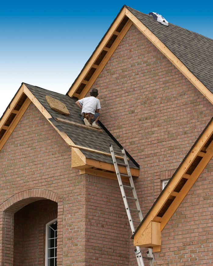 A skilled worker repairing a roof to prevent water damage, a service offered by Papillion Windows & Siding - NE in Papillion, NE.