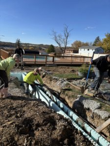 Workers pouring concrete into pool forms during a new pool installation by GM Contracting of West Virginia in Morgantown, WV.