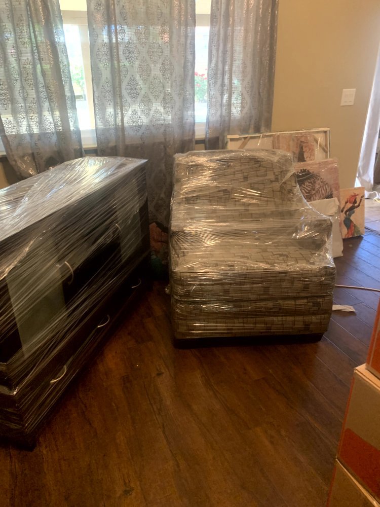 A dresser and armchair professionally wrapped in plastic, ready for moving by Packsen Moving in San Antonio, TX.