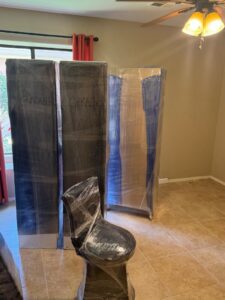 Wrapped furniture items, including a chair, in a room, prepared for moving by Household Goods Moving and Storage in Rockville, MD