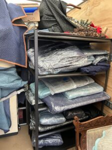 Wrapped items and moving blankets neatly arranged on shelves inside a Next Step Moving truck in Eau Claire, WI.