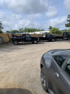 A wrecker tow truck with 'Harry's Towing' branding parked in the lot at Harry's Body Shop & Towing in Jacksonville, FL