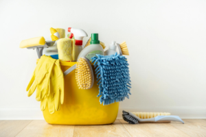 A yellow bucket filled with various cleaning supplies for Smith Solutions, LLC in Camden, DE.