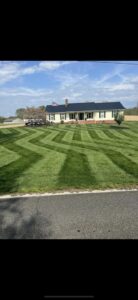 A residential lawn expertly mowed in a decorative zigzag pattern by A & J Lawn Care LLC in Seaford, DE.