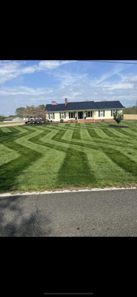 A residential lawn expertly mowed in a decorative zigzag pattern by A & J Lawn Care LLC in Seaford, DE.
